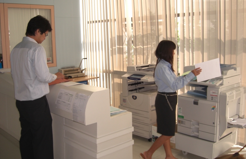 man and woman at photocopier in office