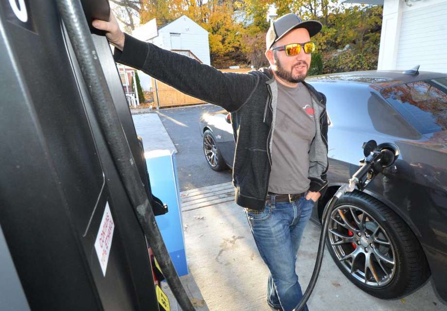 Man pumping gas into his car