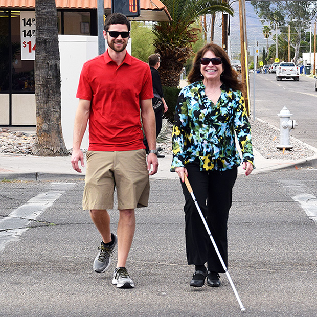 blind person walks with cane