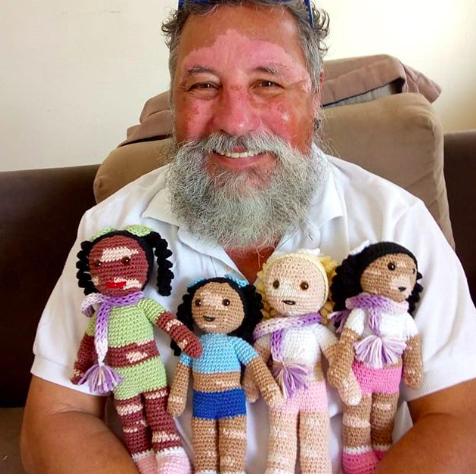 grandfather knits dolls for kids with vitiligo