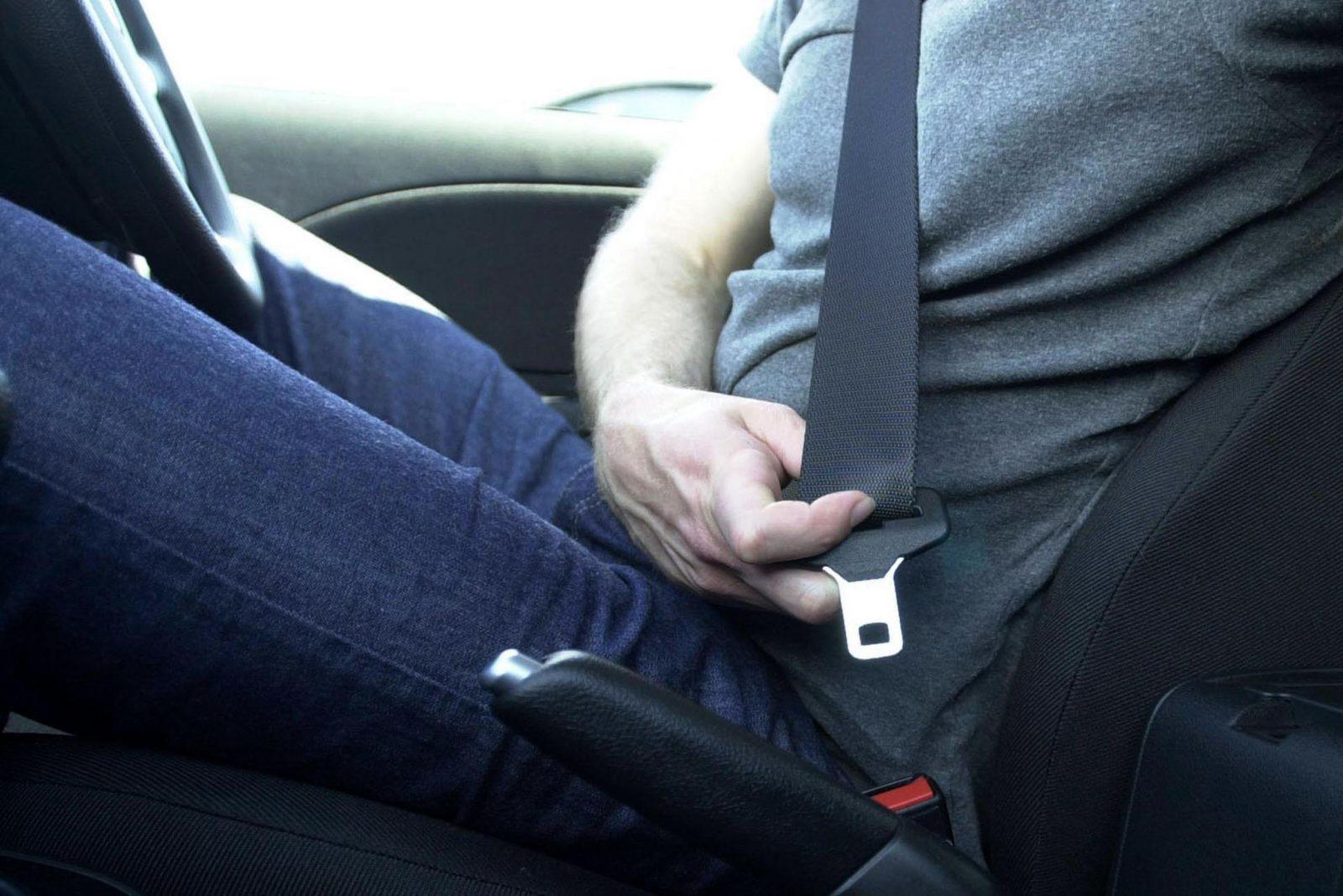 fastening your seatbelt in the car