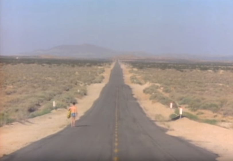 A screenshot from the Talking Heads' music video, "Road to Nowhere".