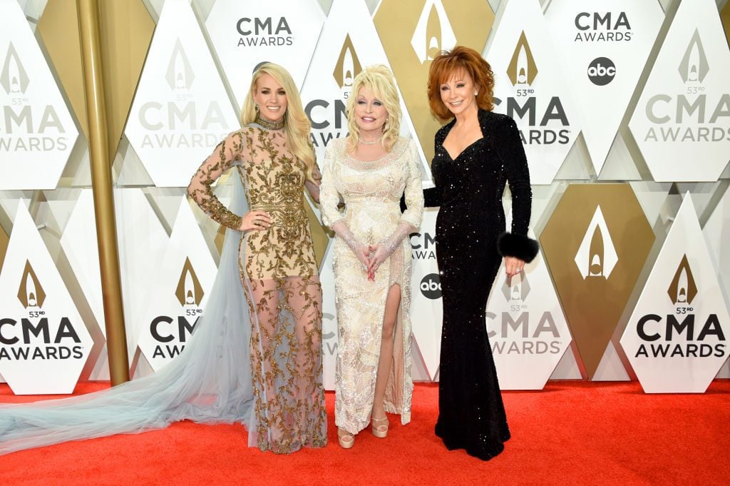  Carrie Underwood, Dolly Parton and Reba McEntire posing on the red carpet at the 53rd annual CMA Awards at the Music City Center on November 13, 2019 in Nashville, Tennessee. 