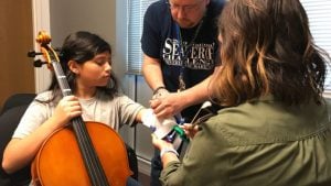 Kayla Arqueta is fitted for her prosthetic, a joint effort between students at Nimitz High School, their instructor, the orchestra teacher, and the Irving Schools Foundation
