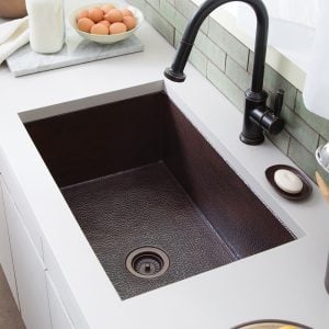 Kitchen sinks don't have one to avoid bacteria building up there