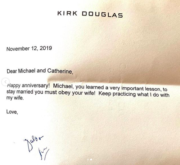 Kirk Douglas offers wisdom to Catherine Zeta-Jones and Michael Douglas