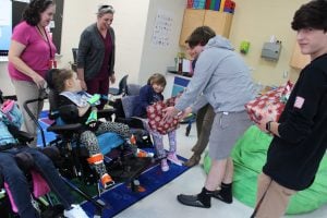 Students handed out switch adapted toys they adjusted for easier play