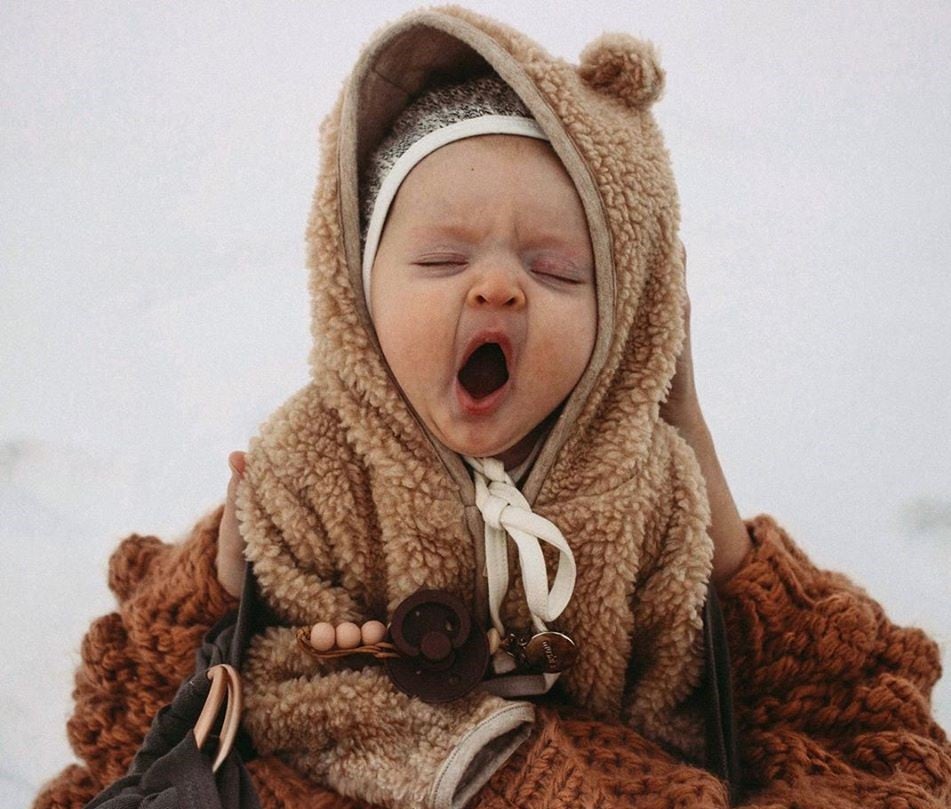 baby in a bear outfit 