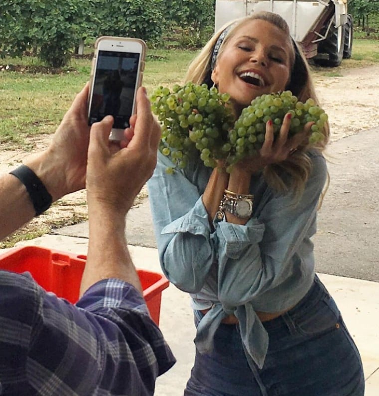 christie brinkley posing with grapes
