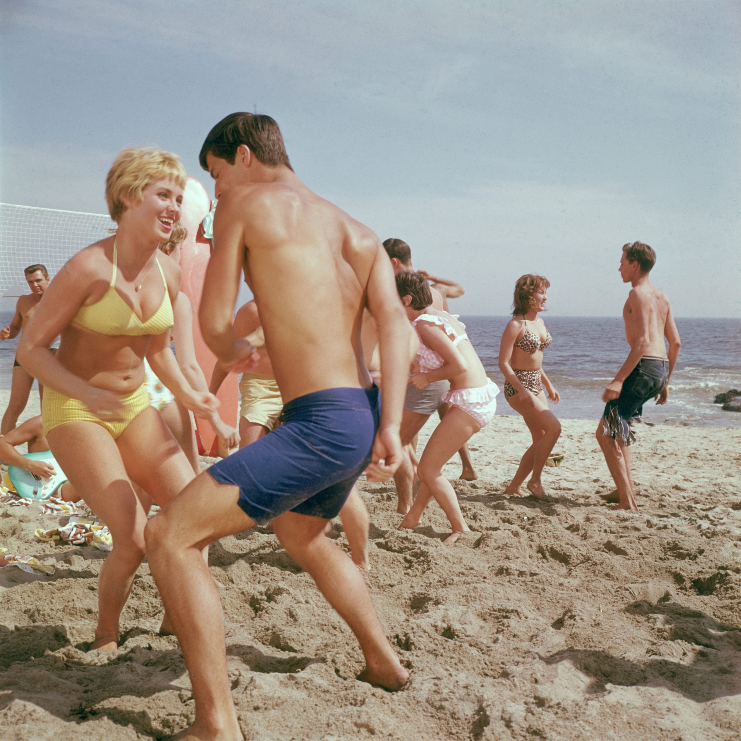 people dancing on a beach 1960s