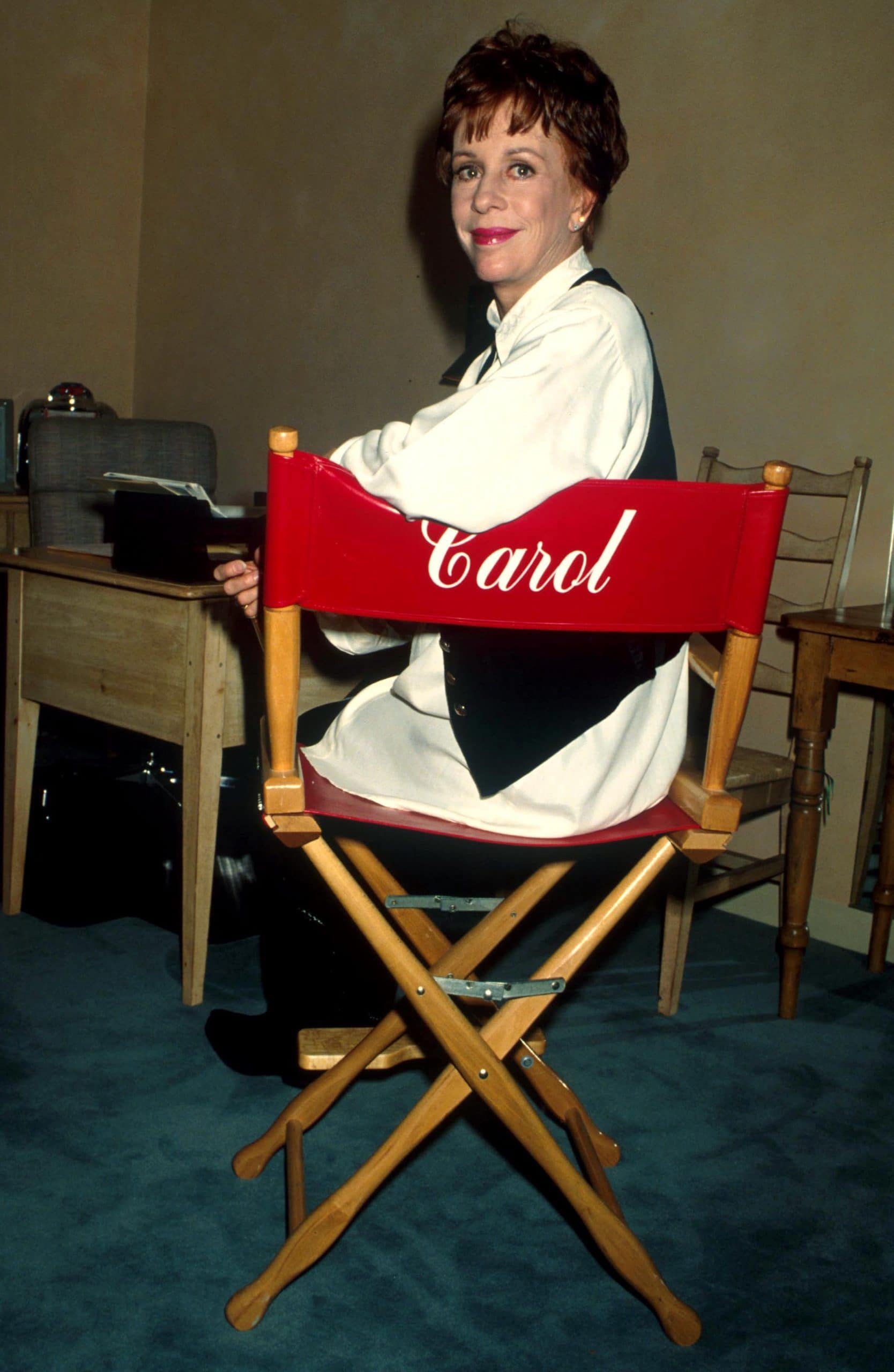carol burnett sitting in a chair with her name on it 