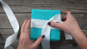 One ribbon that's the right length can create that fancy criss-crossed ribbon to finish a gift off