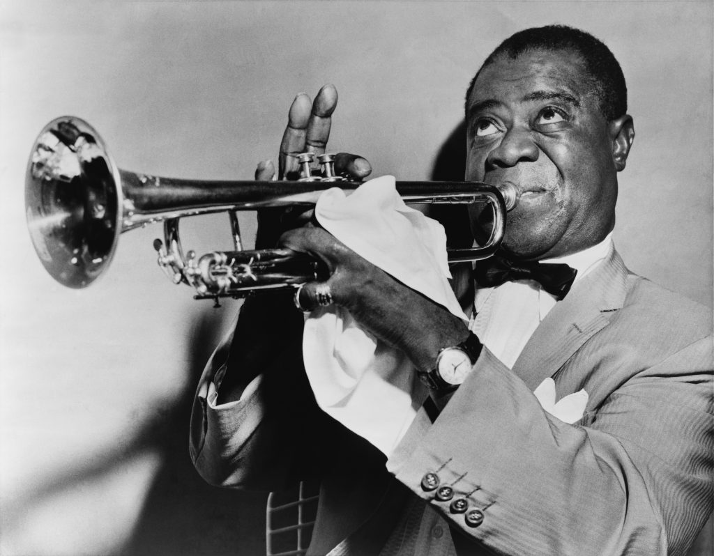 Louis Armstrong playing the trumpet.