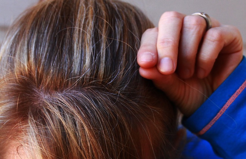 woman plucking gray hair