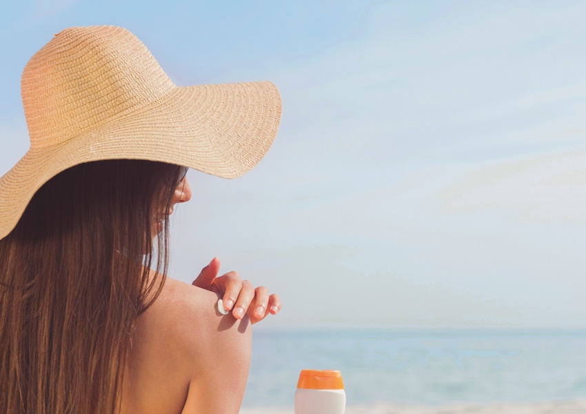 woman applying sunscreen