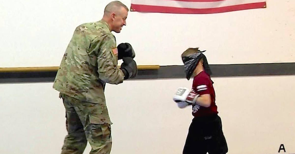 boy spars with deployed dad