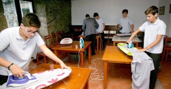 Boys learning how to iron clothes