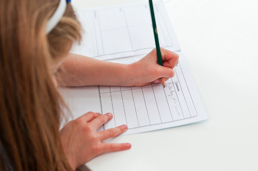 child writing in cursive