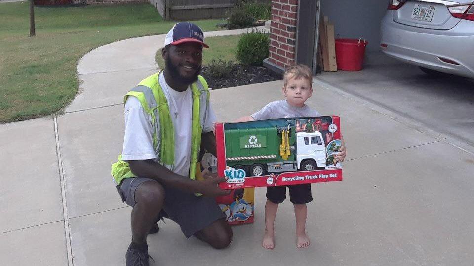 Sanitation worker gives toy recycle truck to kid who regularly greets him