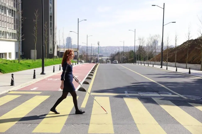 Blind person walks with cane