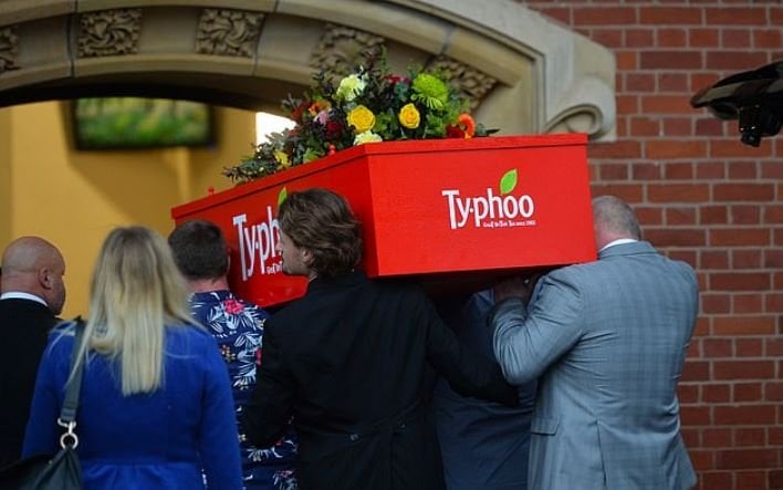 woman buried in a giant tea bag box