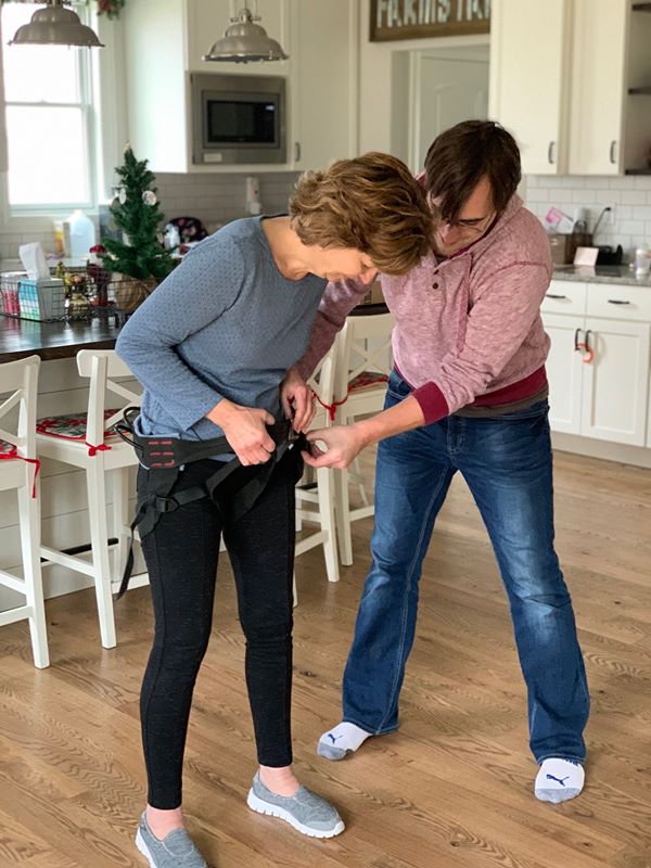 woman putting on harness 