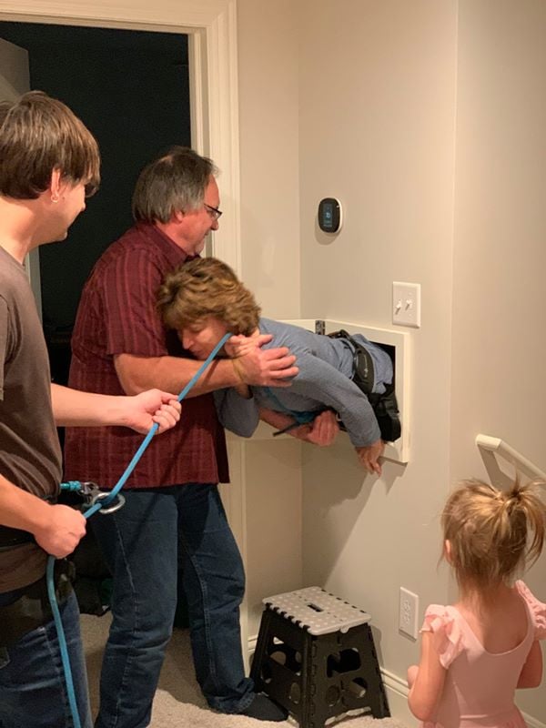 woman being put in laundry chute