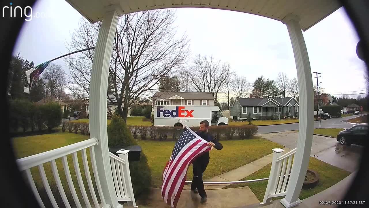 fedex driver stops to fold american flag