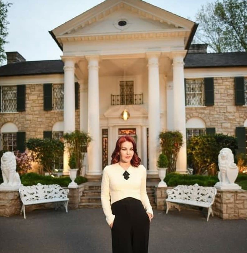 priscilla presley in front of graceland 