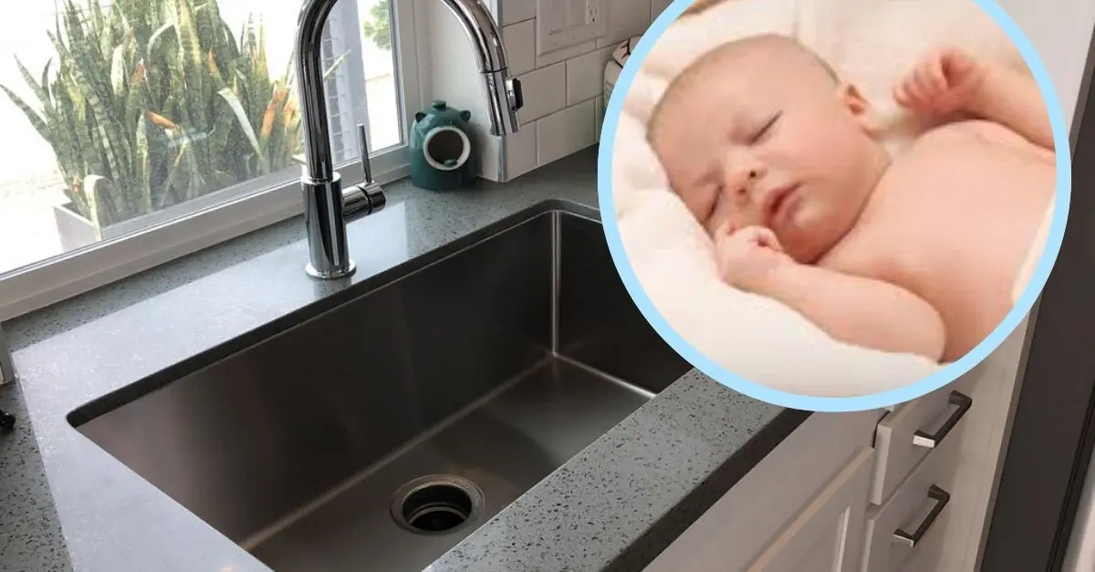 washing baby in the kitchen sink