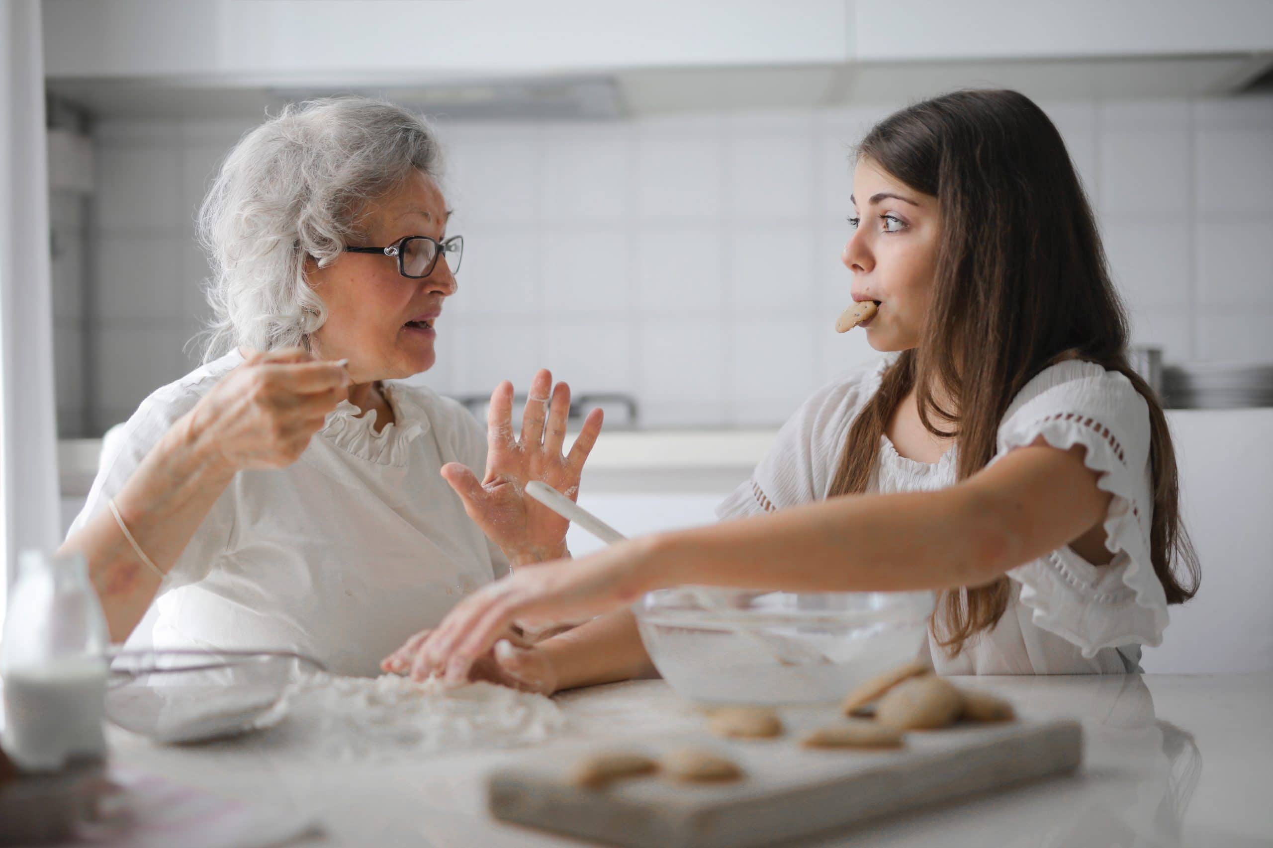 grandmother and granddaughter making cookies