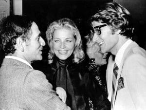 Pierre Cardin attends a party with Lauren Bacall and Yves St. Laurent after starting his empire