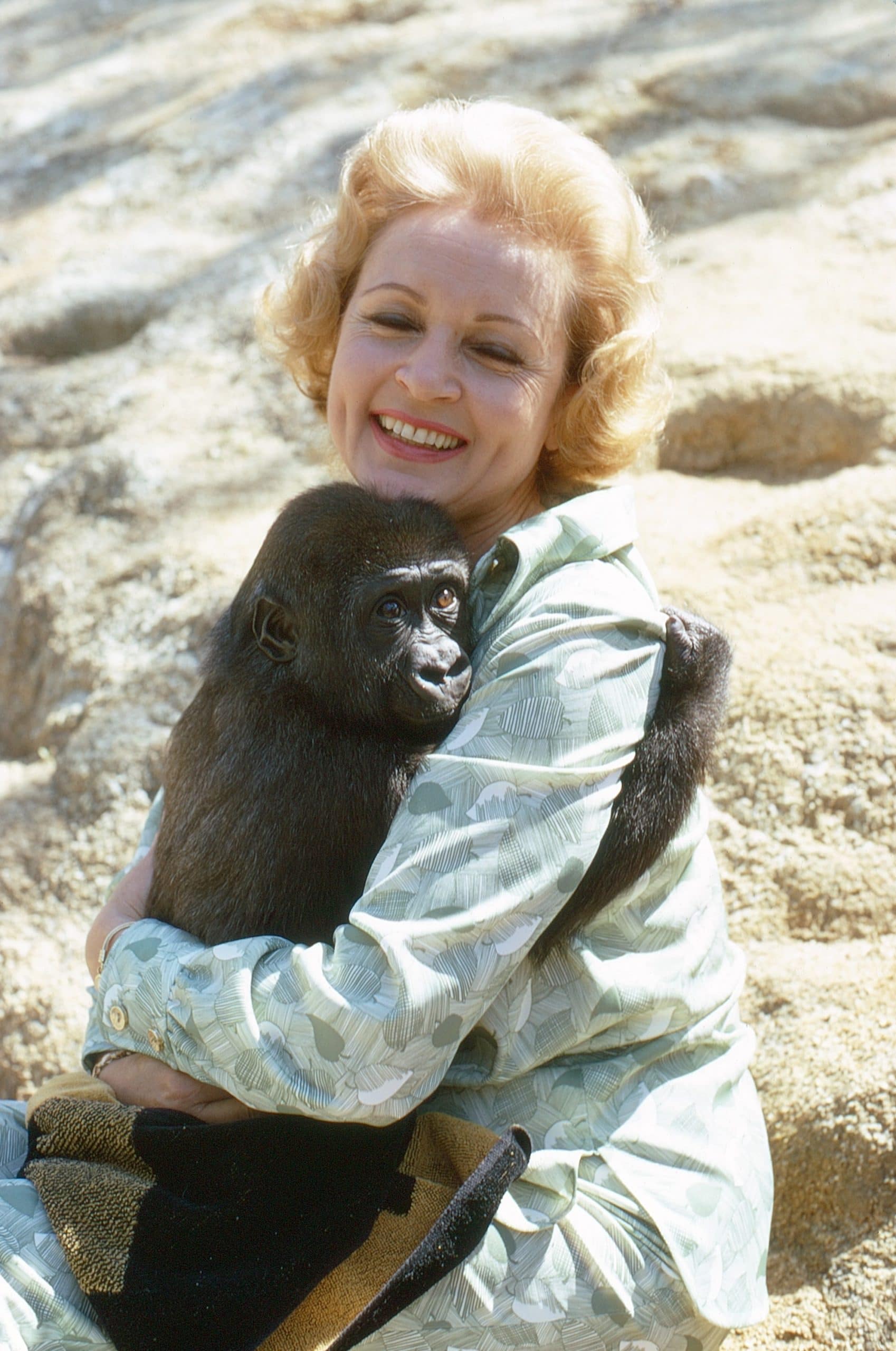 Betty White, embracing a chimpanzee