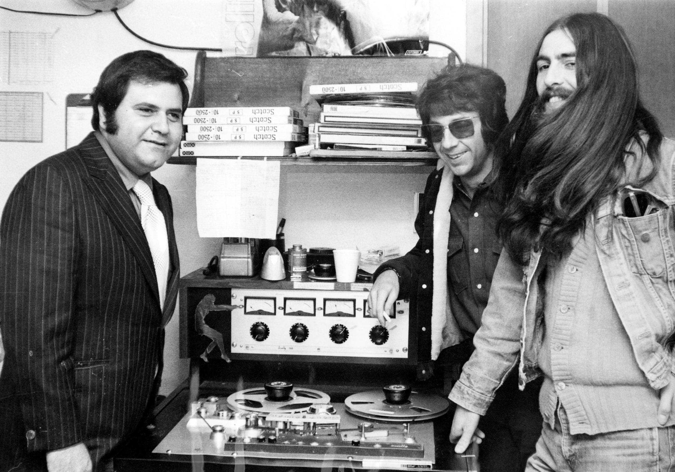 George Harrison (far right) with Apple Records executive Pete Bennett and producer Phil Spector