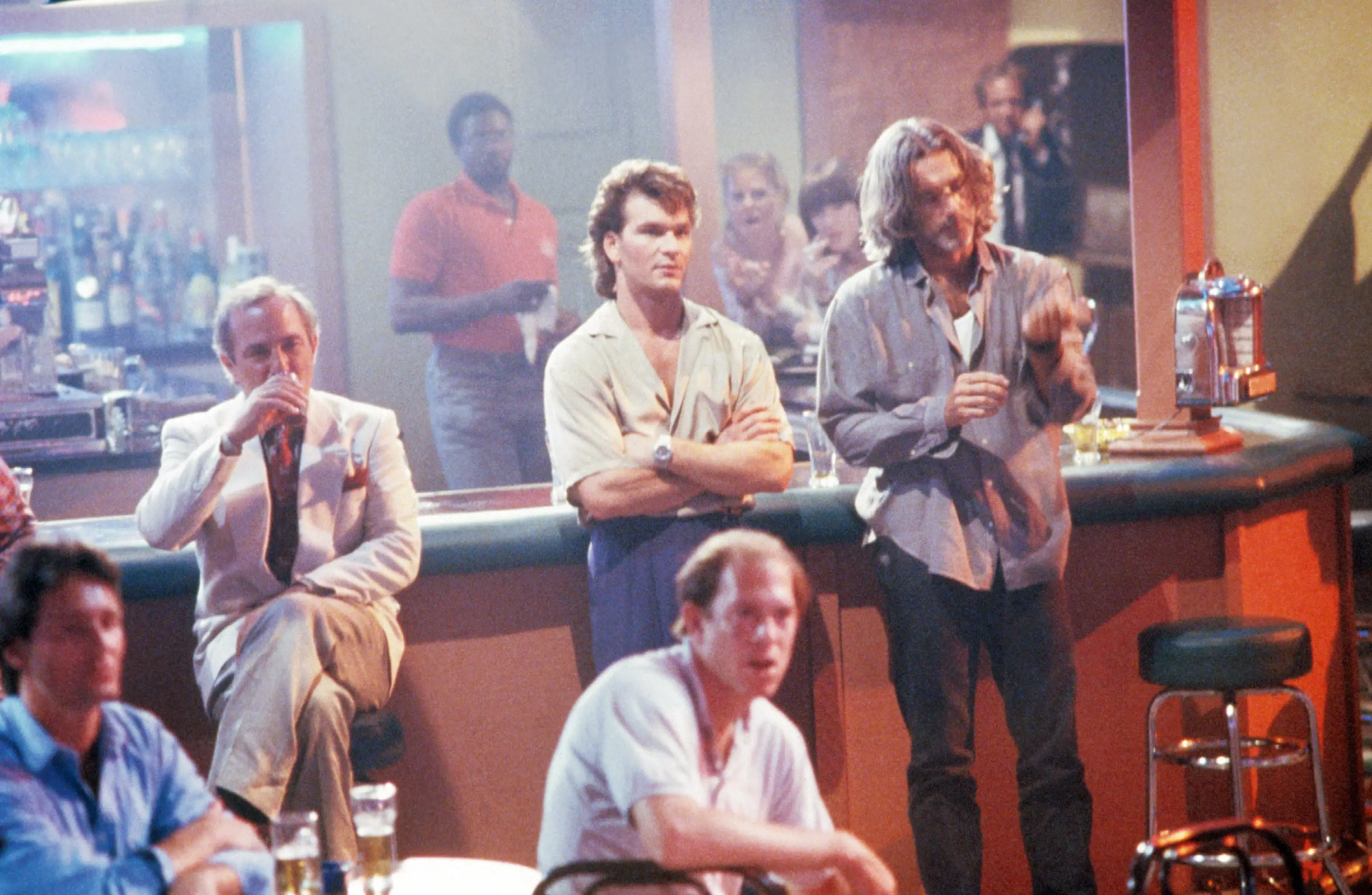 ROAD HOUSE, at bar from left: Ben Gazzara (seated), Patrick Swayze, Sam Elliott, 1989