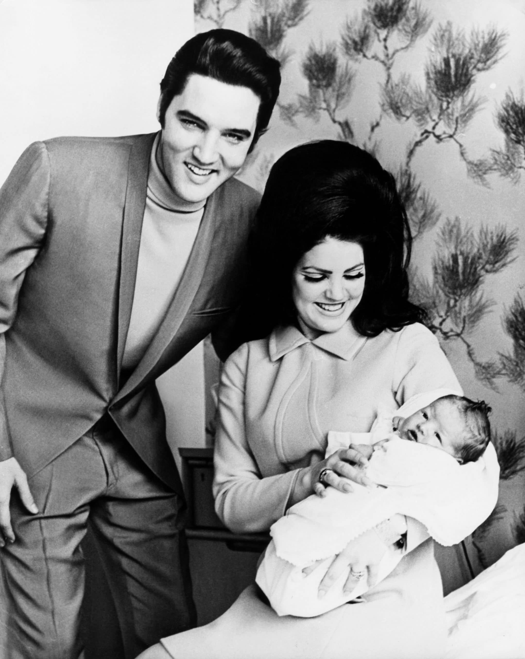 Elvis Presley, Priscilla Presley, with baby Lisa Marie Presley, at home in Memphis, February 1968