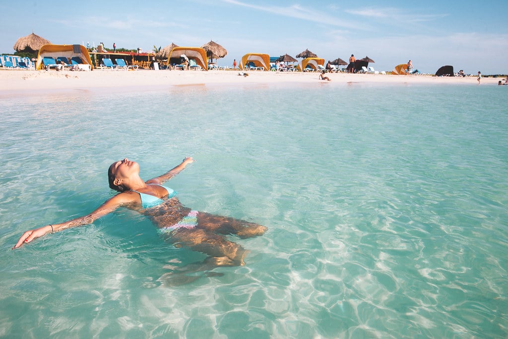 woman tanning soaking up the sun in the water on vacation