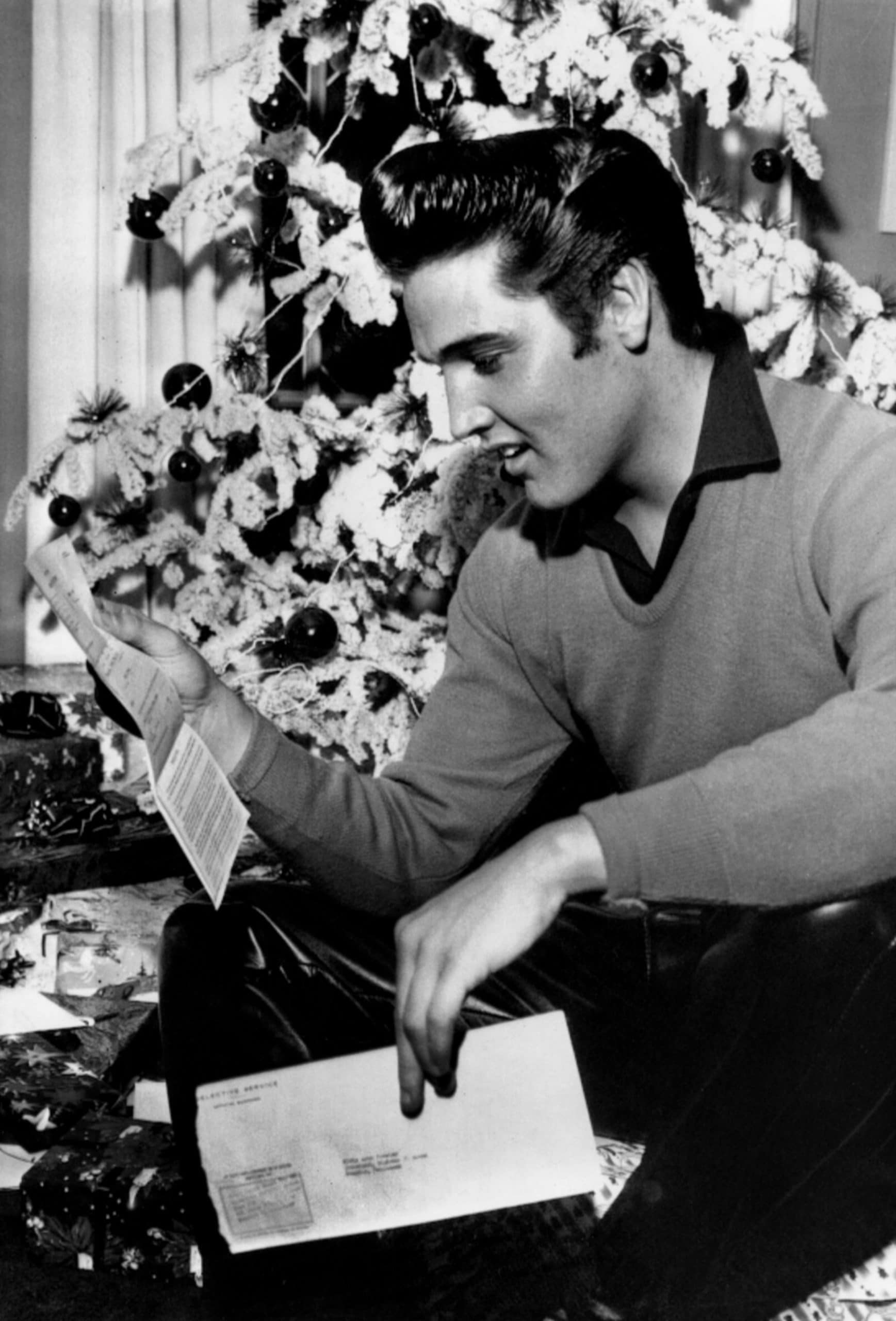 Elvis Presley examines his draft notice, Memphis, TN, December 20, 1957