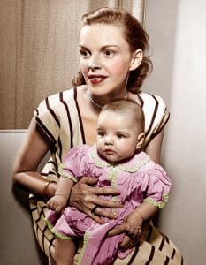 Judy Garland holds baby daughter, Liza Minnelli