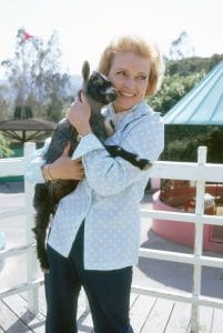 Betty White, holding a baby goat