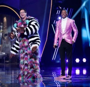 THE MASKED SINGER, from left: Bob Saget (revealed as Squiggly Monster), host Nick Cannon