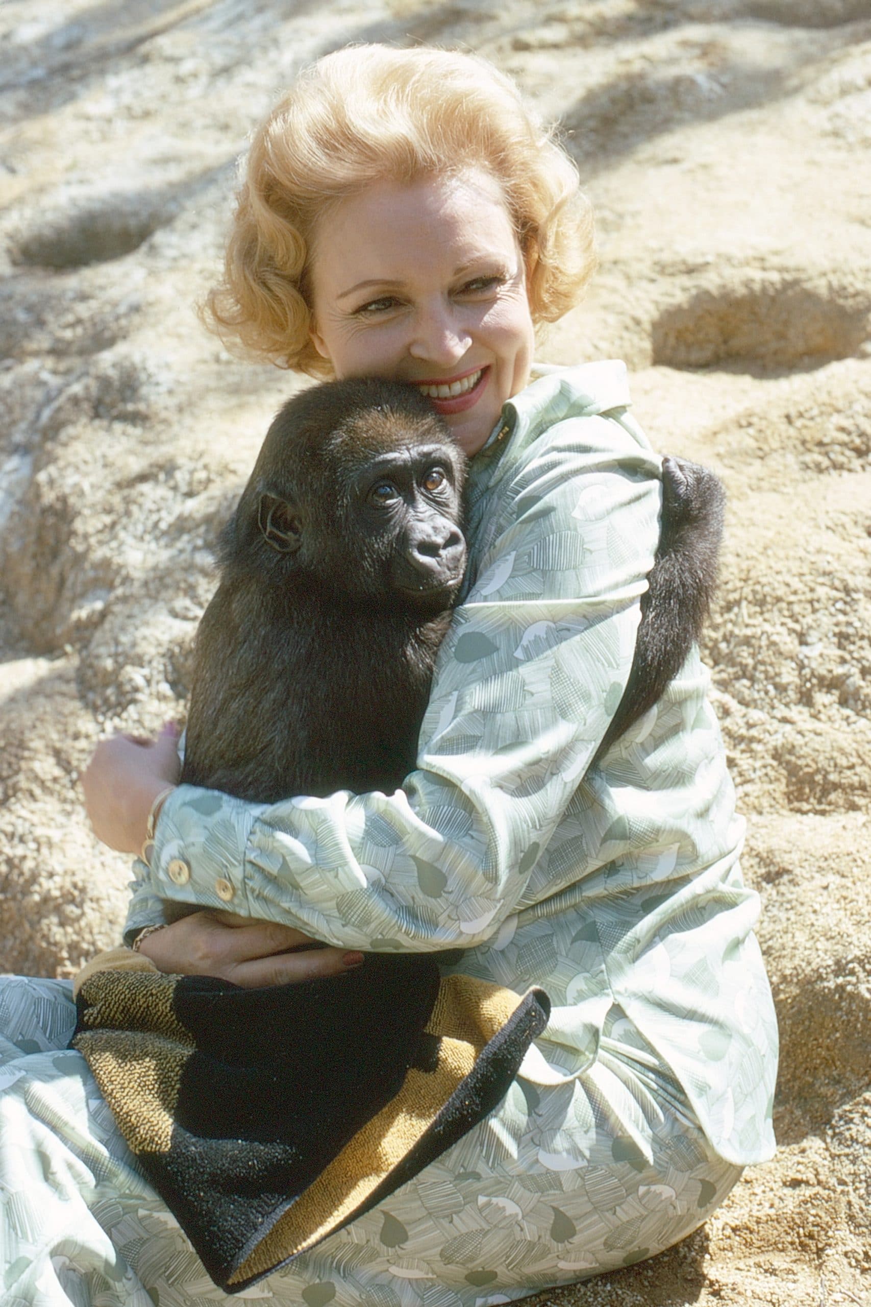 Betty White, embracing a chimpanzee, 1974