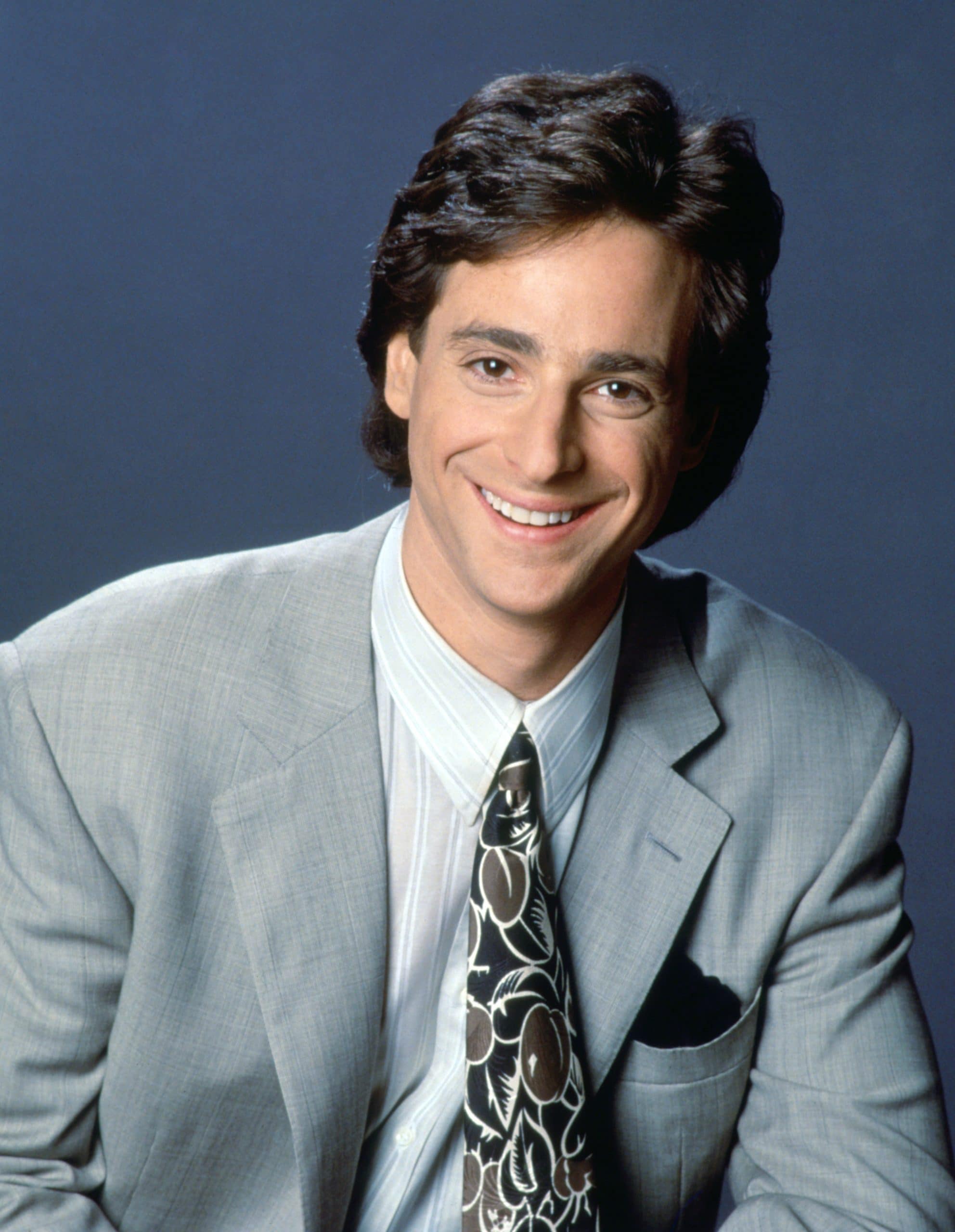 Bob Saget, in dual publicity portrait for FULL HOUSE and AMERICA'S FUNNIEST HOME VIDEOS, 1990