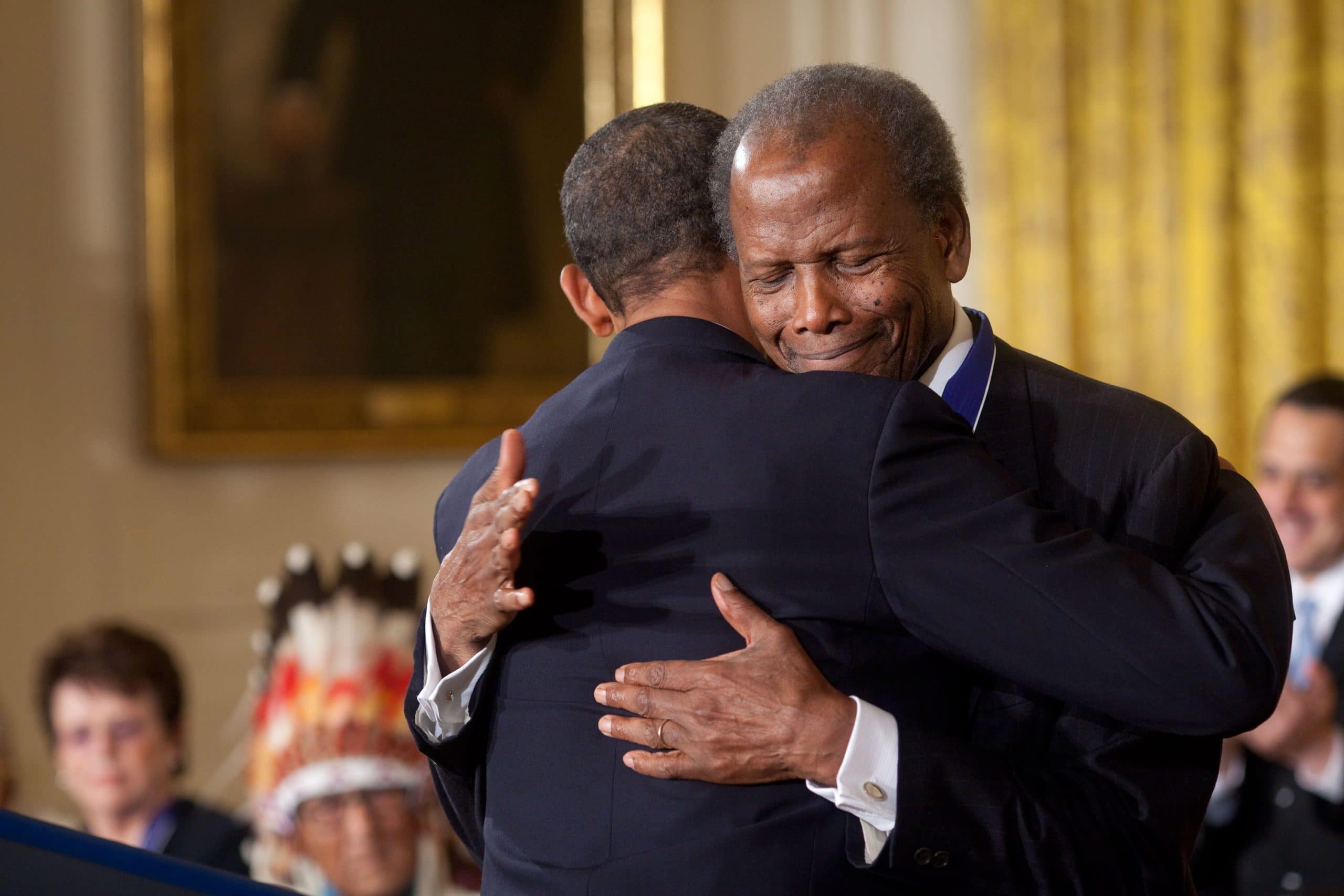 President Obama hugs Sidney Poitier during the award ceremony for the Presidential Medal of Freedom in the White House East Room