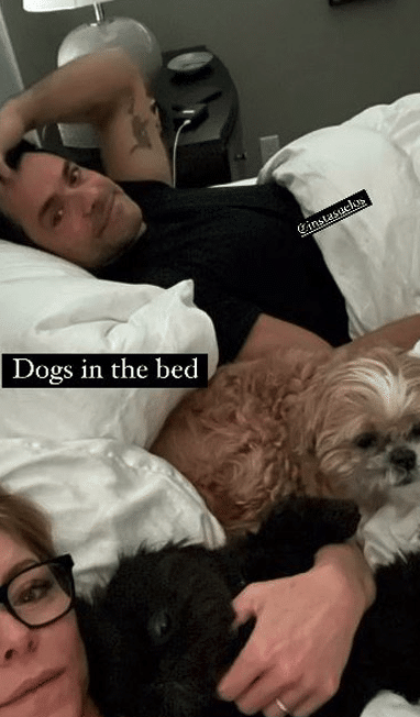 Mark Consuelos chills out in bed with Kelly Ripa and their dogs