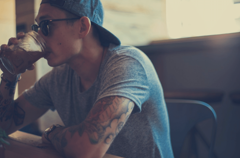 Guy with tattoos dining at a restaurant