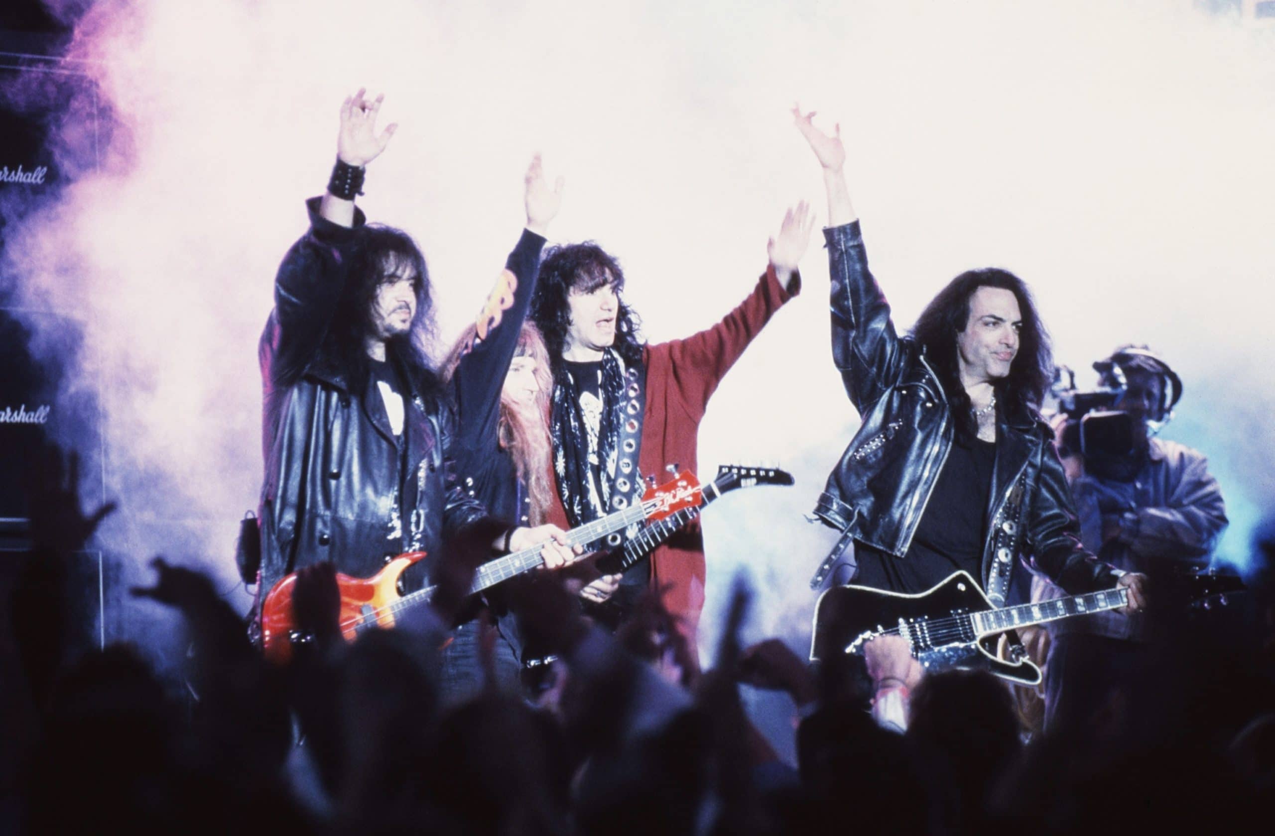 Kiss, on stage (without makeup), from left: Gene Simmons, Eric Singer, Tommy Thayer, Paul Stanley, 1996