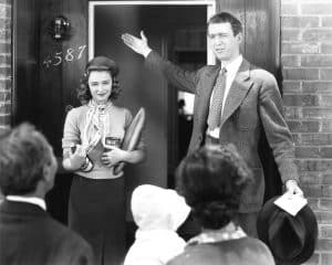 IT'S A WONDERFUL LIFE, from left: William Edmunds (back to camera), Donna Reed, James Stewart