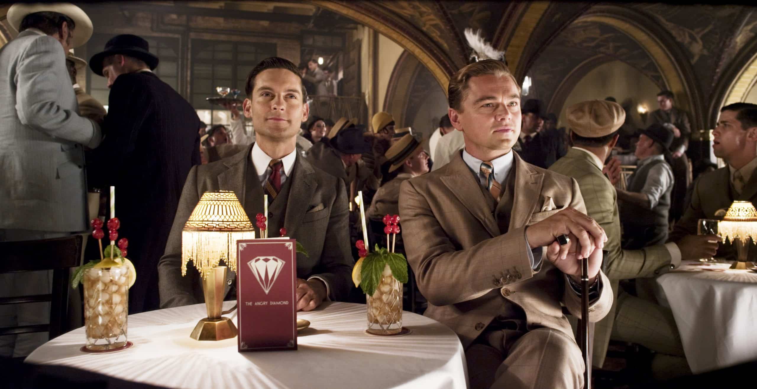 THE GREAT GATSBY, from left: Amitabh Bachchan (standing, far left), Tobey Maguire, Leonardo Di Caprio as Jay Gatsby, 2013