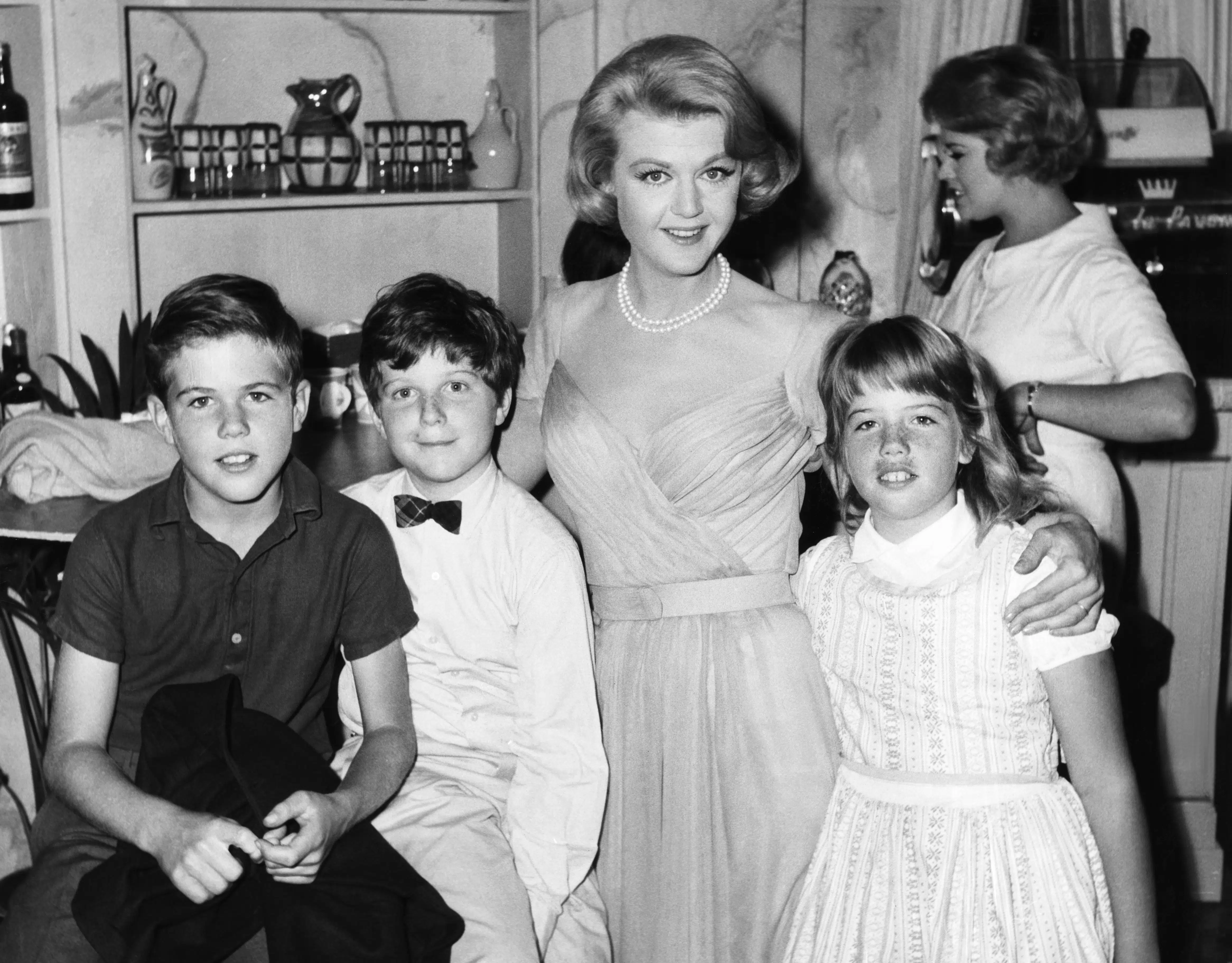 IN THE COOL OF THE DAY, Angela Lansbury (second from right) is visited on set by her children Anthony Pullen Shaw (bow tie) and Deirdre Angela Shaw (right), 1963